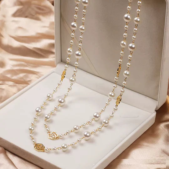 Elegant gold necklace with a small pearl.
