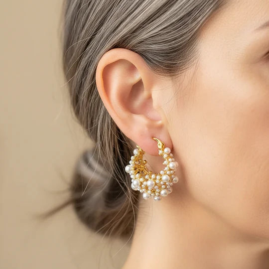 Gold earrings with a vintage design and pearls.