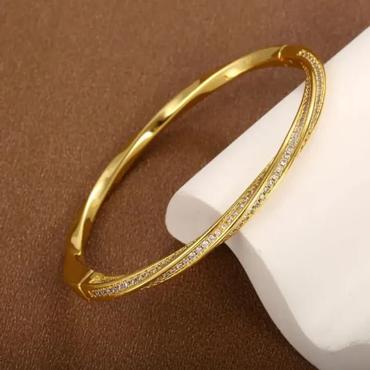 Elegant crystal bracelet with two rows of gold detailing.