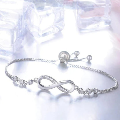 Adjustable bracelet with an infinity symbol in silver color.