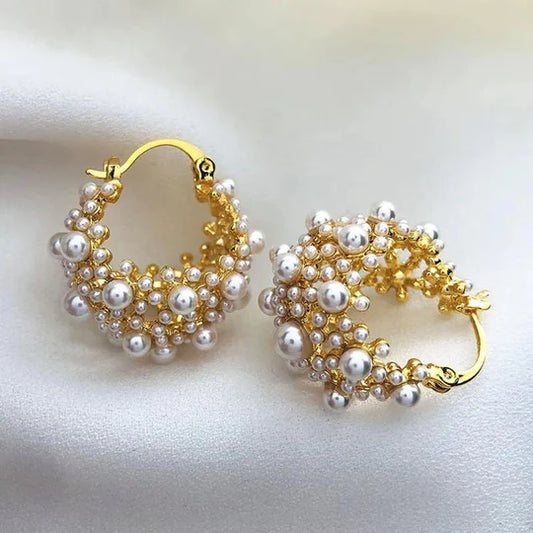 Gold earrings with a vintage design and pearls.
